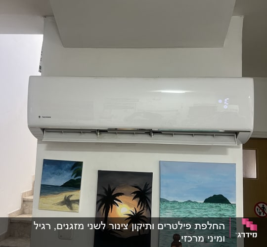 מזגן מותקן על קיר עם ציורי נוף